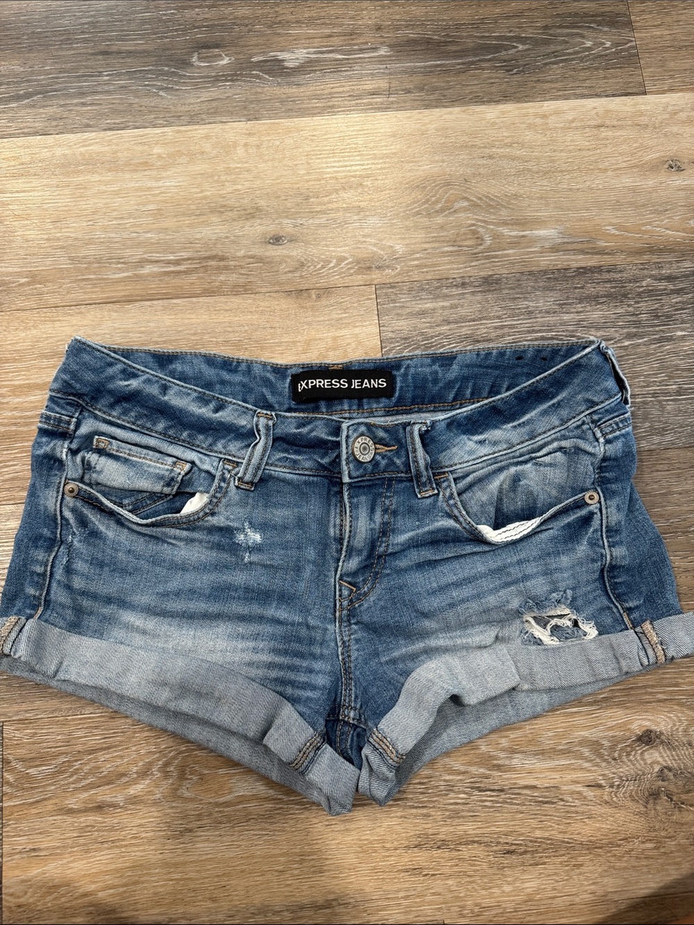 Express Jeans Women's Distressed Denim Shorts in Medium Blue